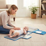 Baby changing pad with multiple attachments and a baby on it
